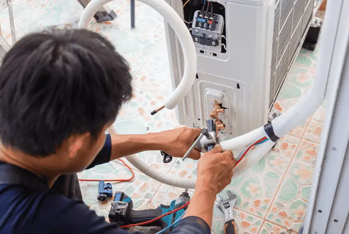 Trusted Air Conditioning Contractor in Killarney servicing a home AC unit