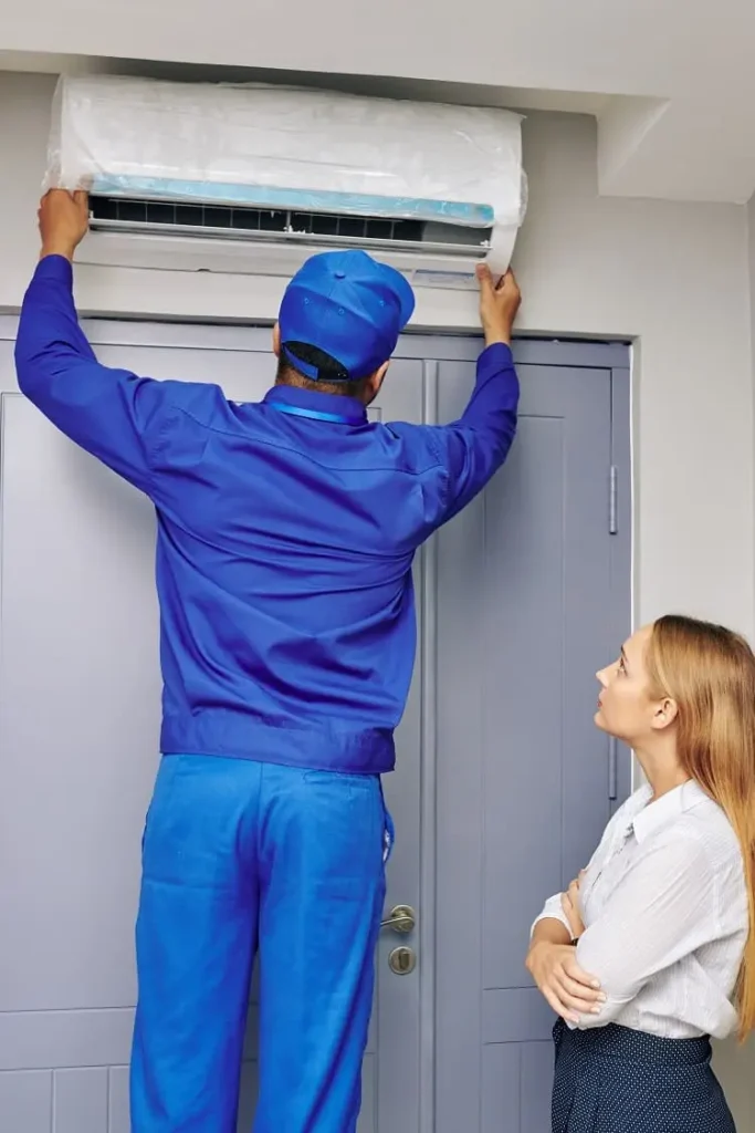 Reliable Air Conditioning Contractor in Tildenville performing routine maintenance on a home AC system.